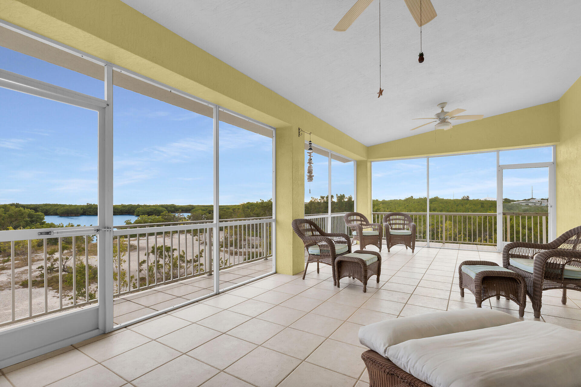85 Ocean Shores Drive Key Largo, FL 33037 - Photo 39 of 77 a living room with patio furniture and a floor to ceiling window