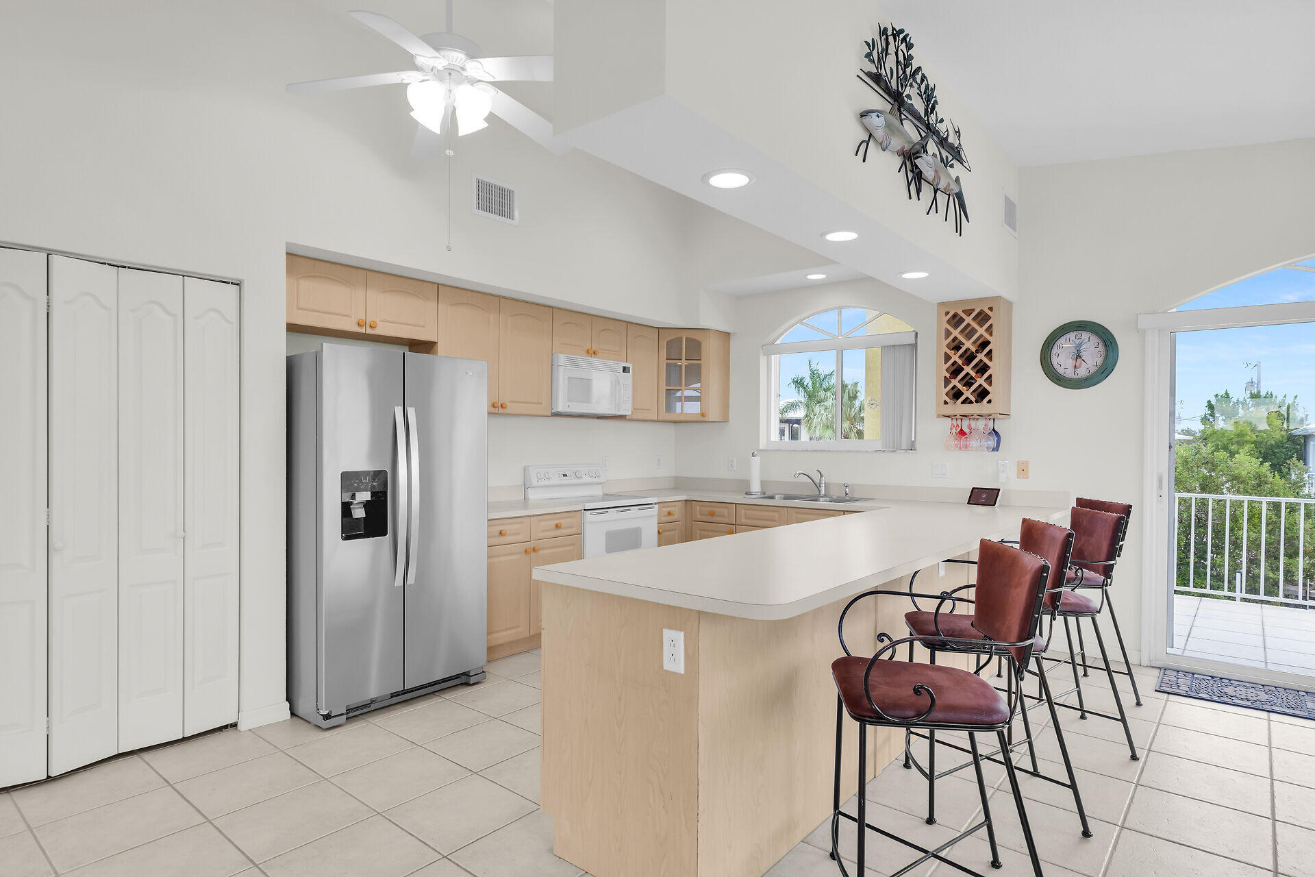 85 Ocean Shores Drive Key Largo, FL 33037 - Photo 44 of 77 a view of a dining room with furniture and a clock on the wall