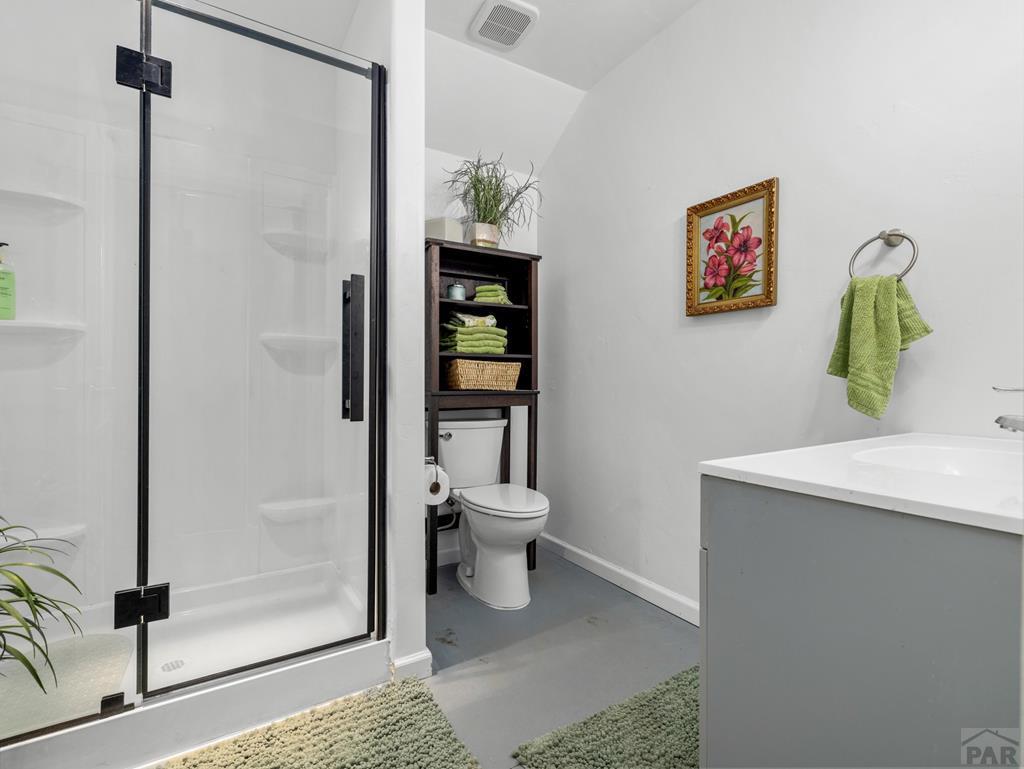 8760 Ridge Road Beulah, CO 81023 - Photo 31 of 45 a bathroom with a toilet a sink and shower
