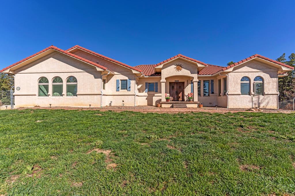 8760 Ridge Road Beulah, CO 81023 - Photo 10 of 45 a front view of a house with a yard