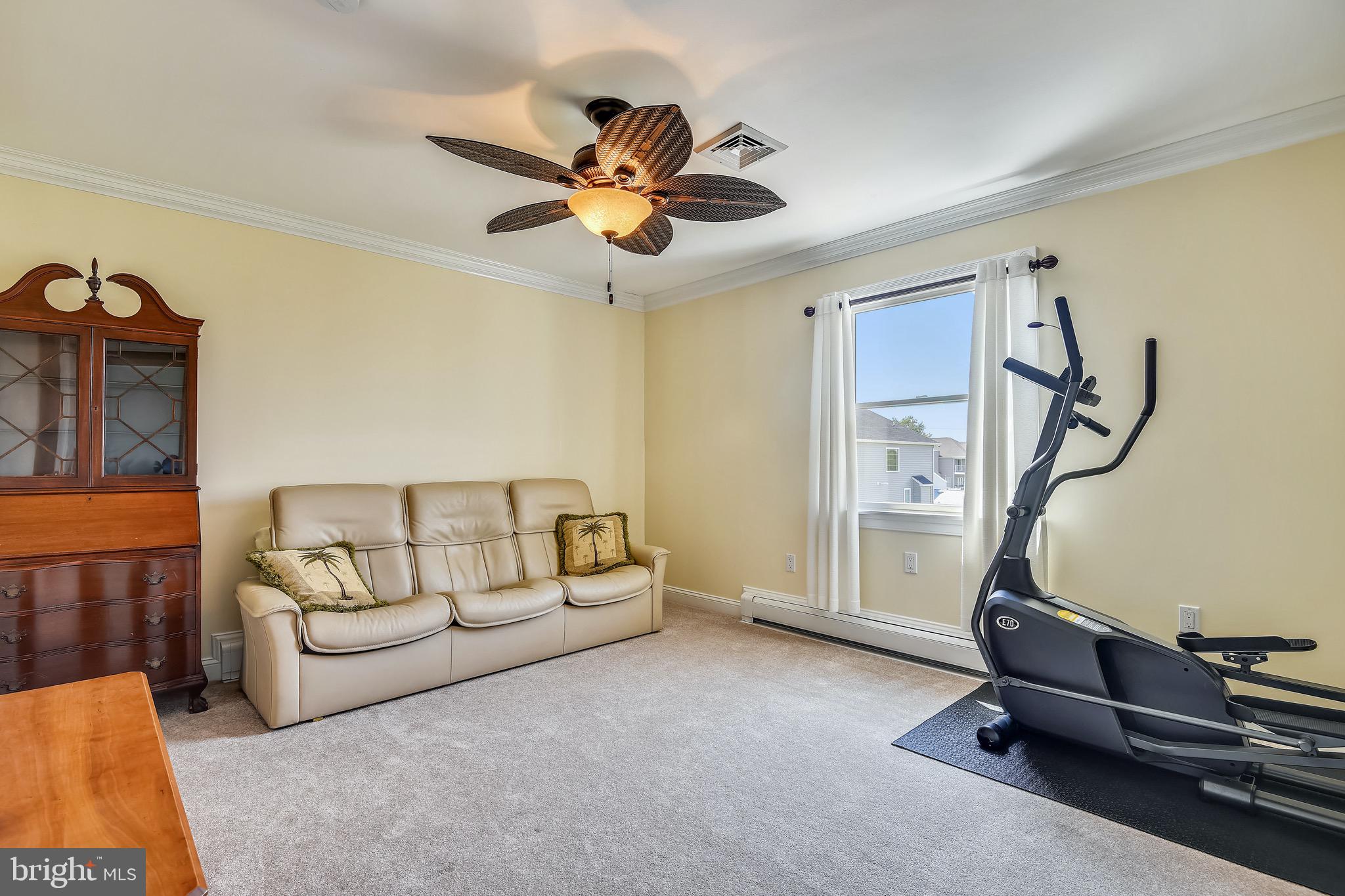 9109 Cuckold Point Road Baltimore, MD 21219 - Photo 36 of 37 a living room with furniture and a ceiling fan