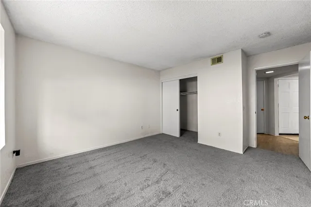 an empty room with closet area