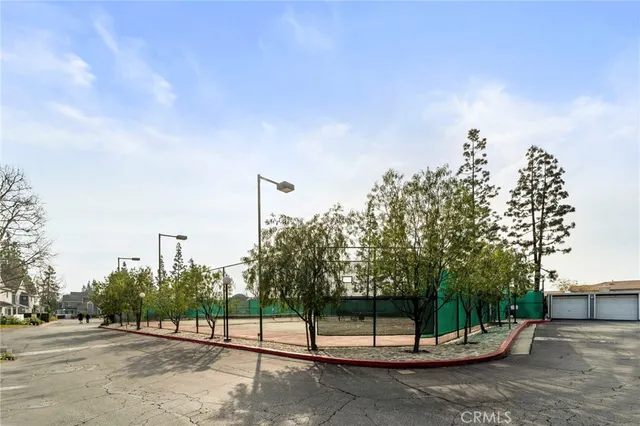 a roof deck with table and chairs a barbeque and potted plants