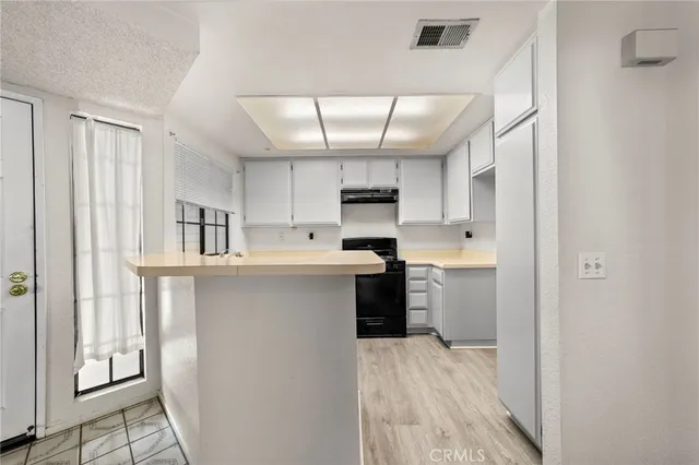 a kitchen with refrigerator cabinets and a sink