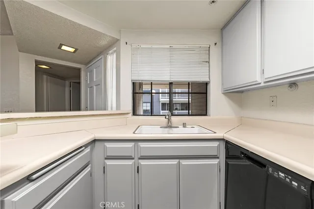 a kitchen with a sink and a window