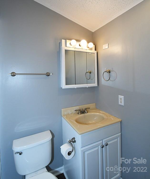 216 Jones Road Mocksville, NC 27028 - Photo 39 of 48 a bathroom with a toilet sink and mirror