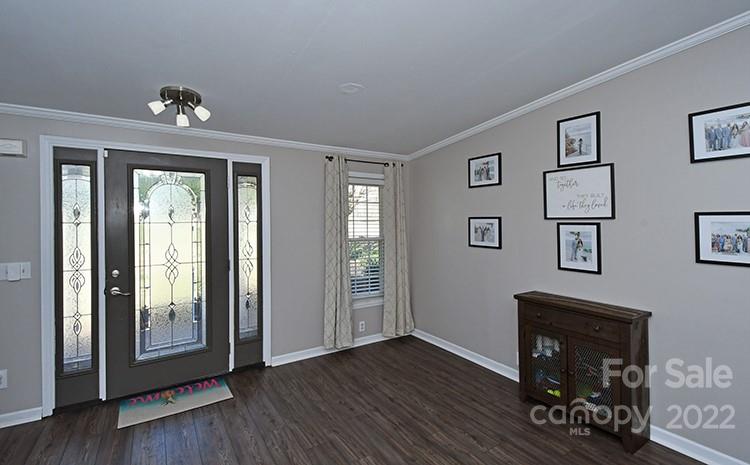 216 Jones Road Mocksville, NC 27028 - Photo 6 of 48 a hallway with wooden floor chandelier and glass door