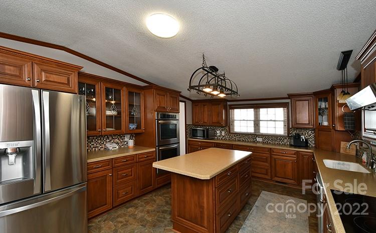 216 Jones Road Mocksville, NC 27028 - Photo 10 of 48 a kitchen with stainless steel appliances granite countertop a sink a stove and a refrigerator