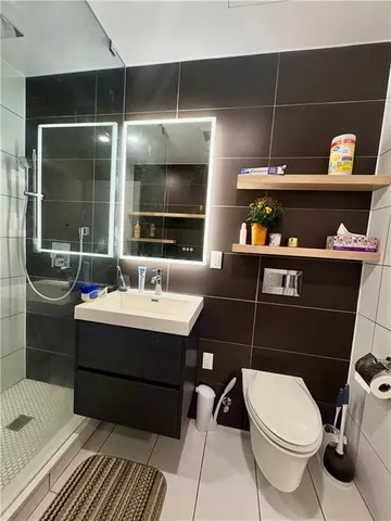 a bathroom with a sink toilet and shower