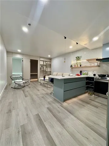 a kitchen with stainless steel appliances kitchen island sink stove and cabinets