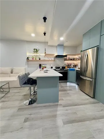 a kitchen with a sink stainless steel appliances and cabinets