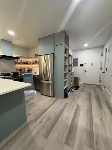 a kitchen with stainless steel appliances a refrigerator and a stove