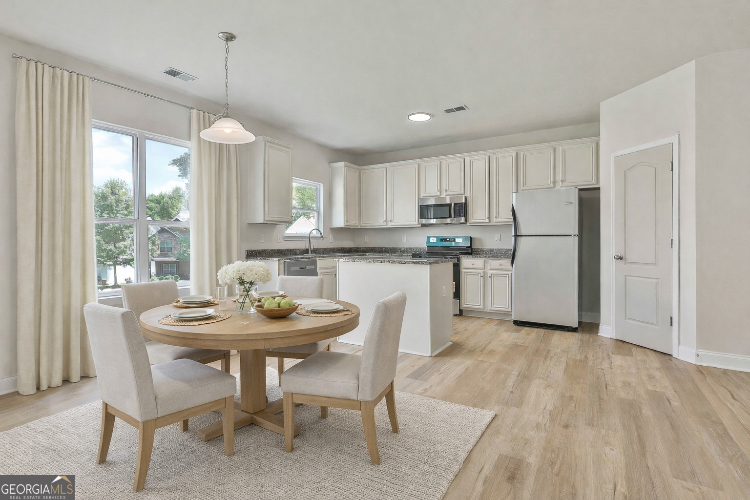 28 Fox Ridge Drive Newnan, GA 30265 - Photo 16 of 47 a kitchen with kitchen island a dining table and chairs