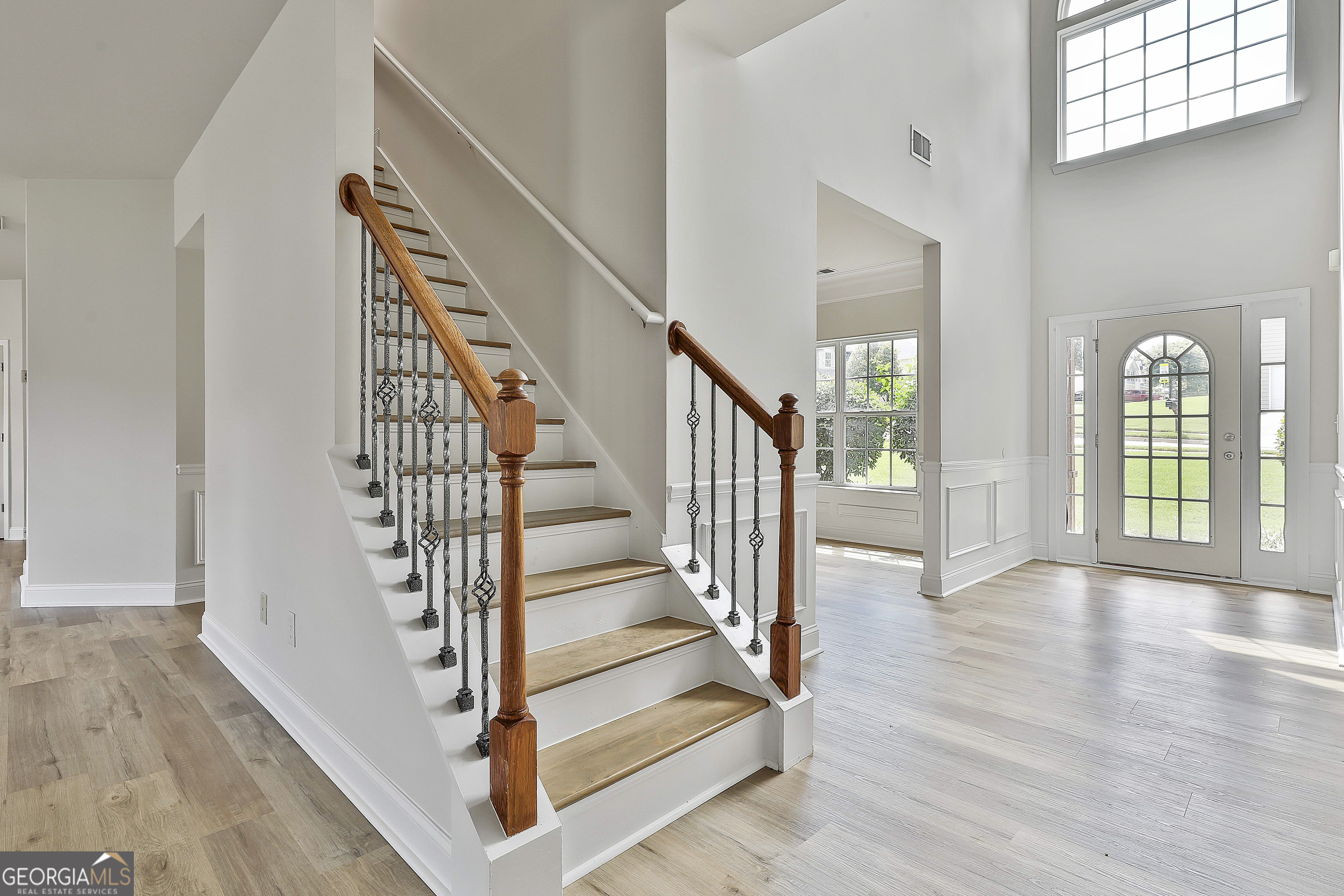 28 Fox Ridge Drive Newnan, GA 30265 - Photo 22 of 47 a view of staircase with wooden floor and a large window