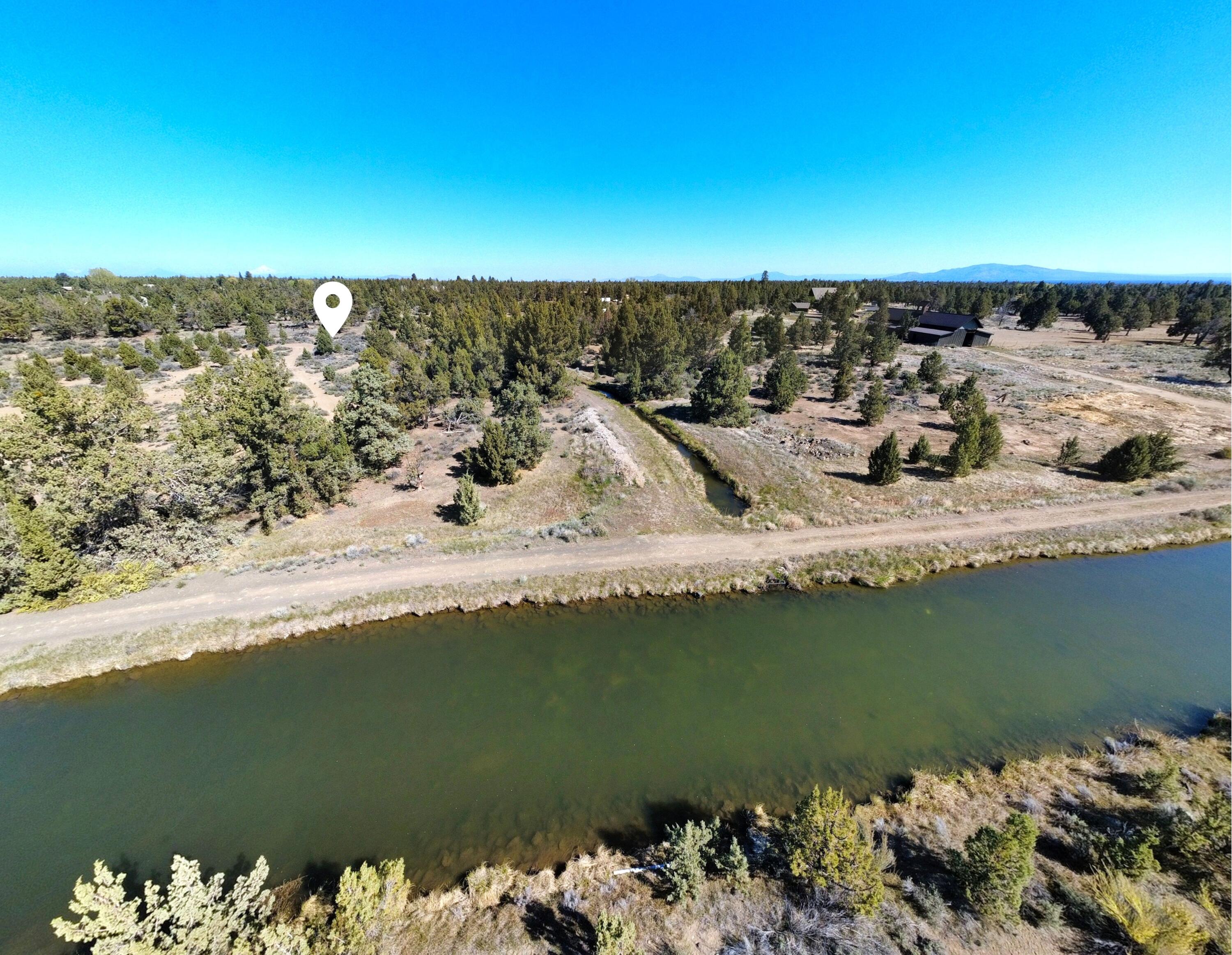 61590 Gribbling Road, Unit LOT 2 Bend, OR 97701 - Photo 5 of 12 a view of a lake with a mountain