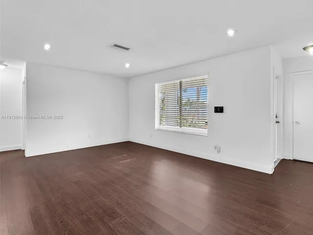 a view of kitchen with refrigerator and window
