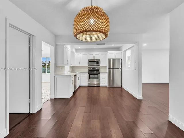 a kitchen with a refrigerator and a sink