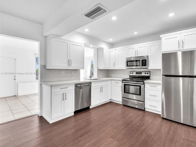 a bedroom with bed and a potted plant