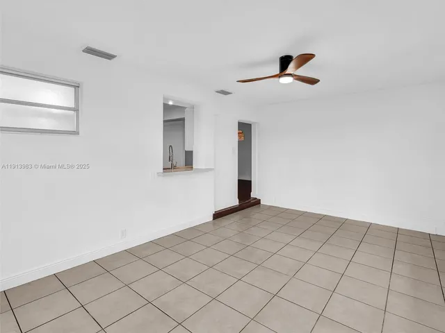 a view of a backyard with plants and outdoor seating