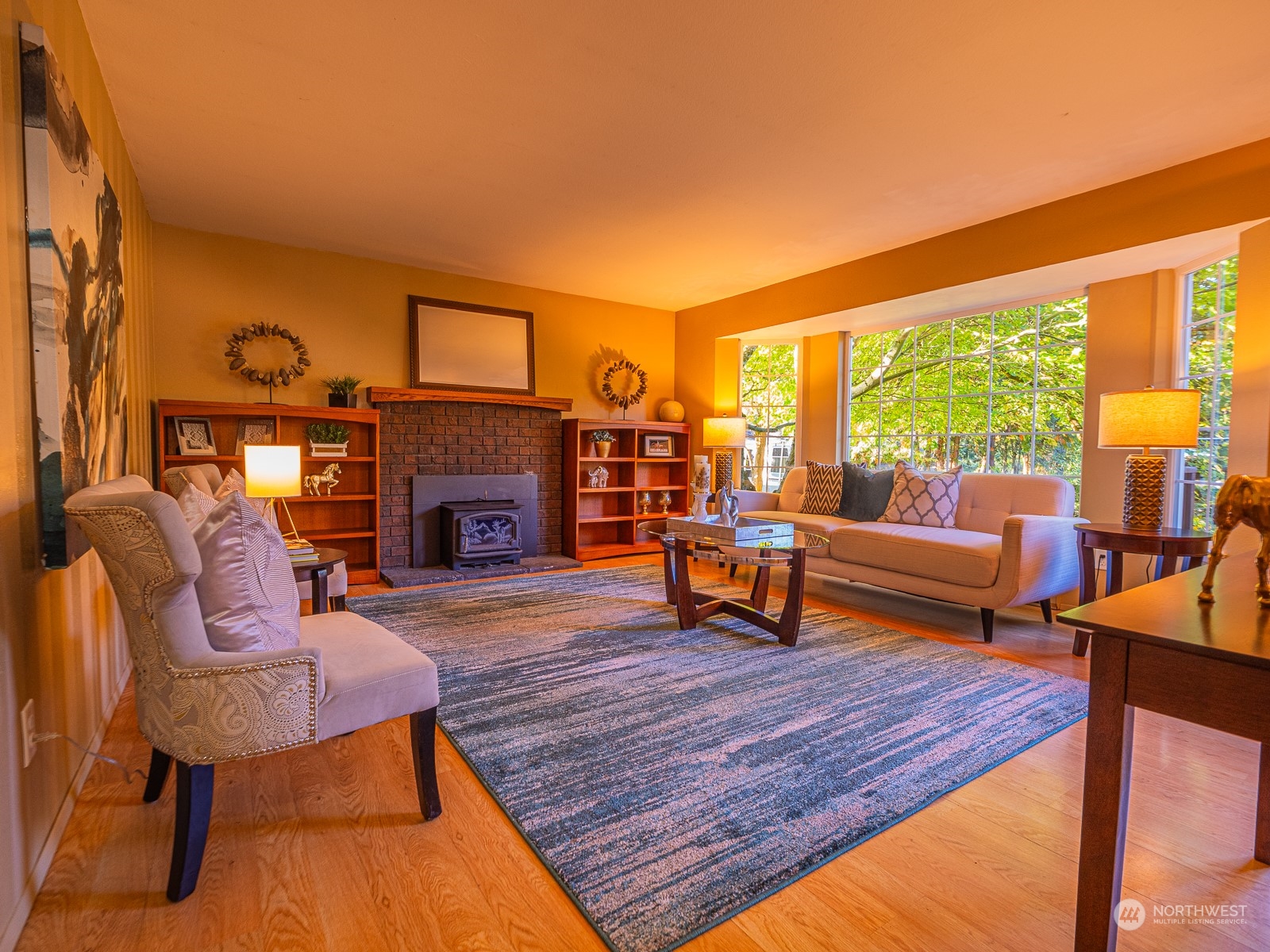 21425 Damson Road Bothell, WA 98021 - Photo 6 of 25 a living room with furniture a fireplace and a floor to ceiling window