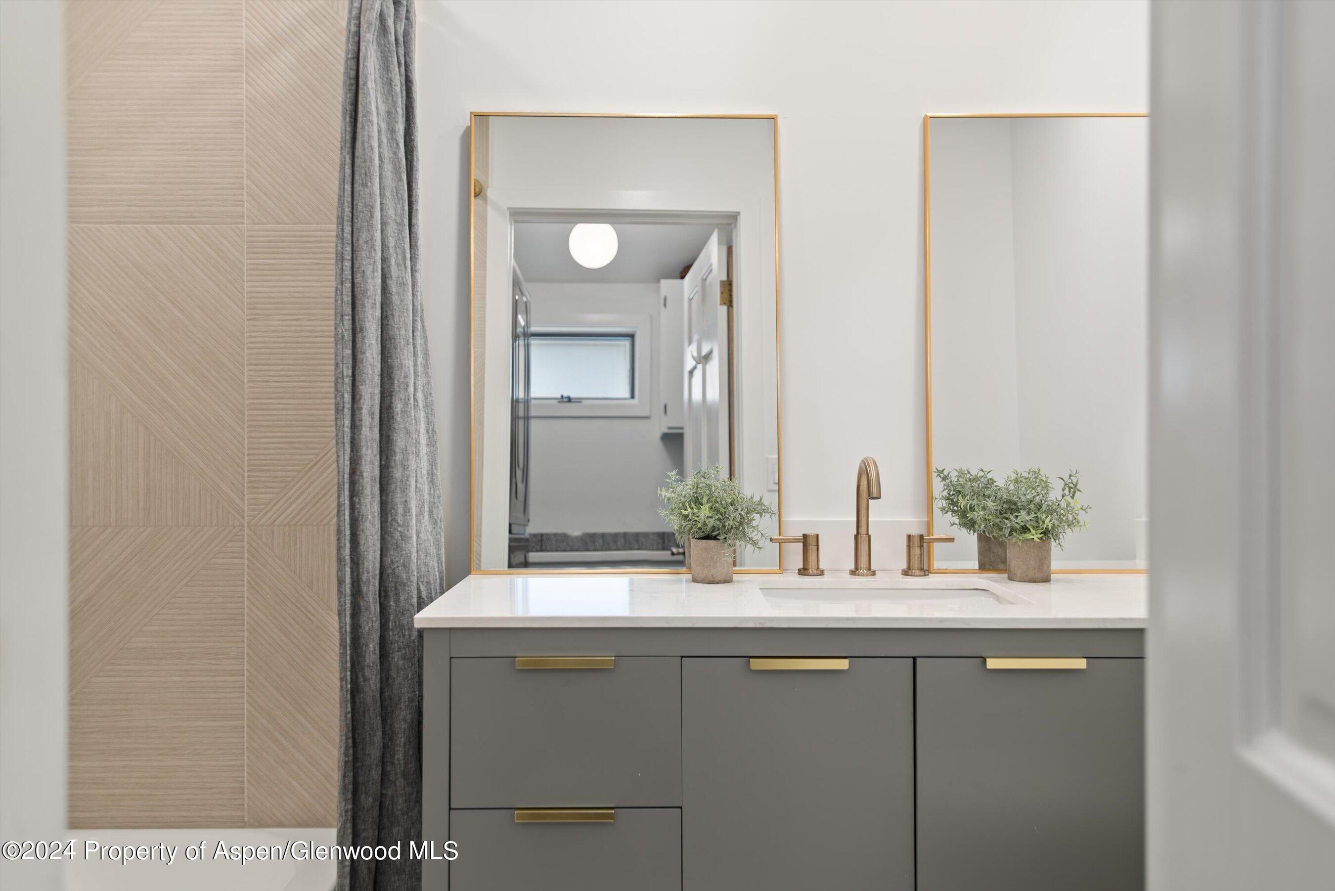 140 Maple Lane Aspen, CO 81611 - Photo 26 of 37 a bathroom with a sink and a mirror