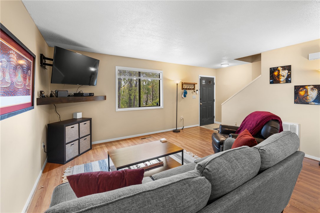 119 Freedom Drive, Unit 8 Clemson, SC 29631 - Photo 7 of 39 This inviting living area features warm wood flooring and a bright window overlooking serene greenery.