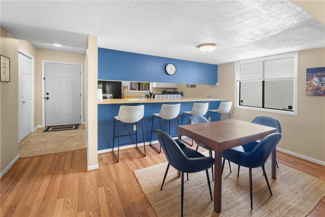 119 Freedom Drive, Unit 8 Clemson, SC 29631 - Photo 8 of 39 This inviting dining area blends seamlessly with a practical kitchen bar, offering versatile living.