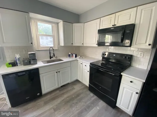a kitchen with a sink stove and microwave