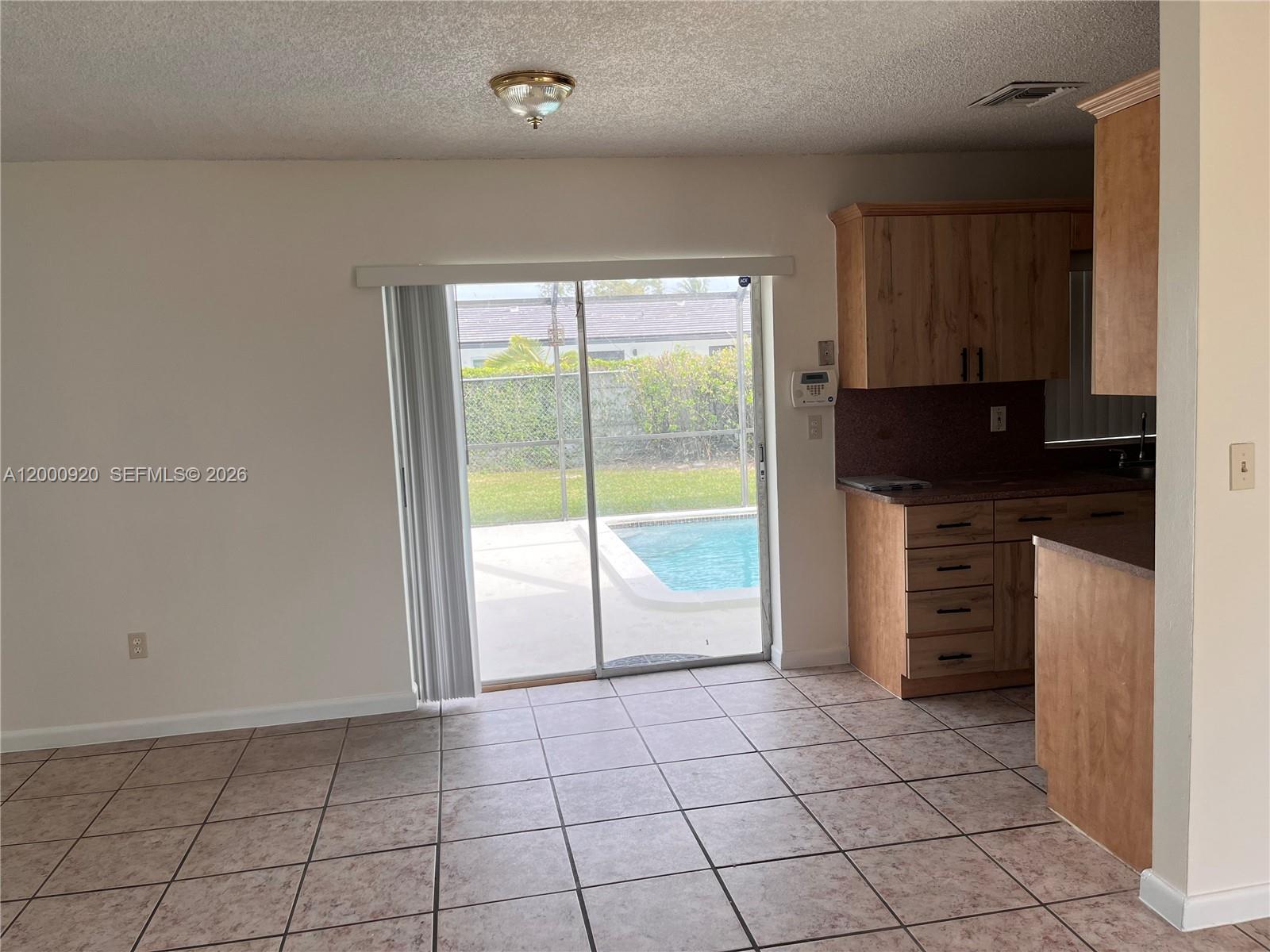 20341 Southwest 117th Avenue Miami, FL 33177 - Photo 5 of 12 a kitchen with a refrigerator a stove top oven and cabinets
