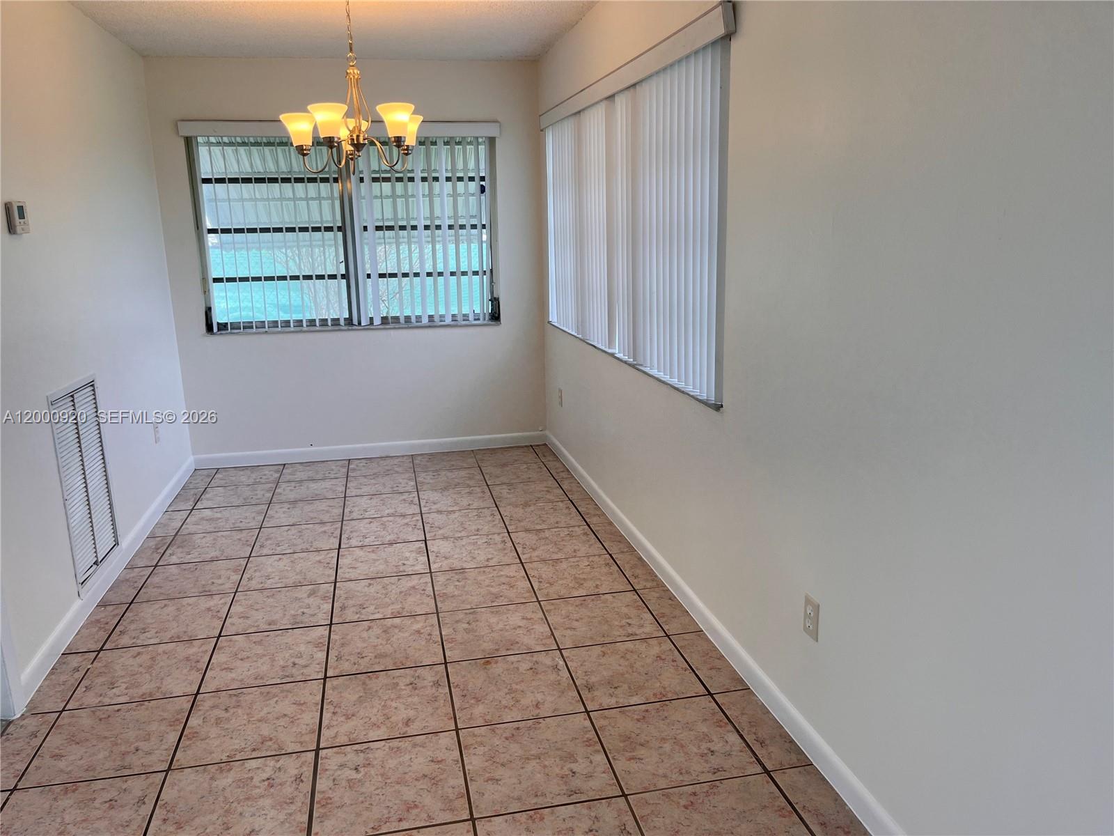 20341 Southwest 117th Avenue Miami, FL 33177 - Photo 6 of 12 wooden floor in an empty room with a window