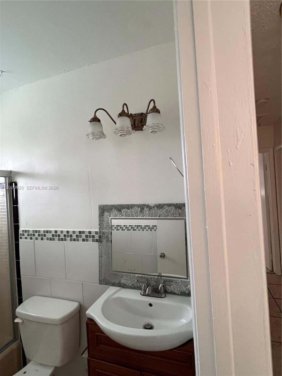 20341 Southwest 117th Avenue Miami, FL 33177 - Photo 8 of 12 a bathroom with a sink and a mirror