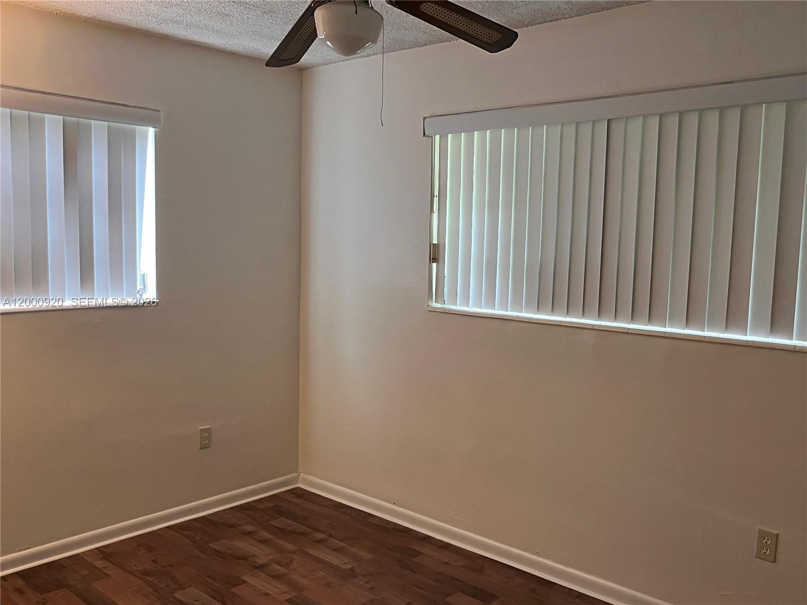 20341 Southwest 117th Avenue Miami, FL 33177 - Photo 10 of 12 a view of an empty room with wooden floor and a window