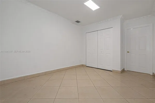 an empty room with white walls and tiles