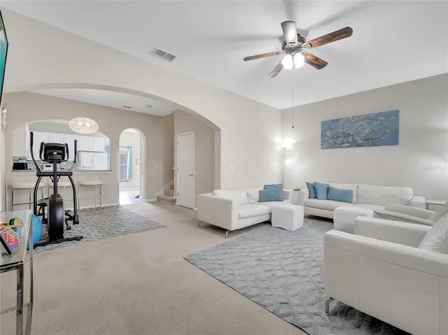 a living room with furniture and a lamp