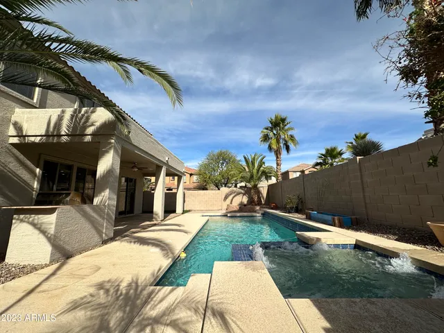 a view of a backyard with sitting area
