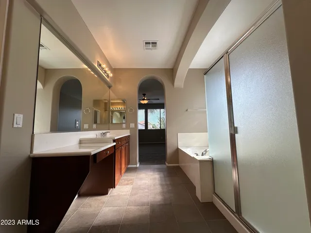 a bathroom with a double vanity sink and a mirror