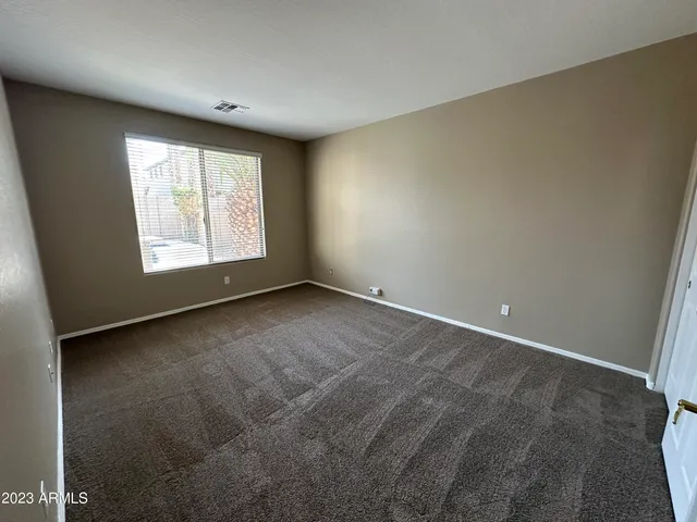 a view of a pathway with a wrought fence