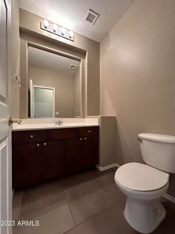 a view of a house with a patio and a yard