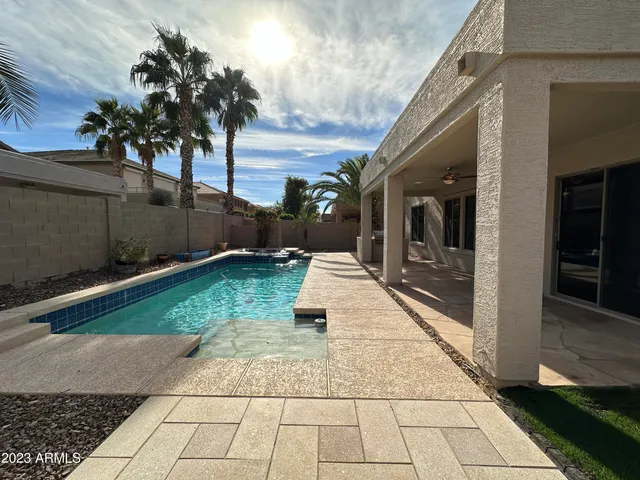 a view of swimming pool with a patio
