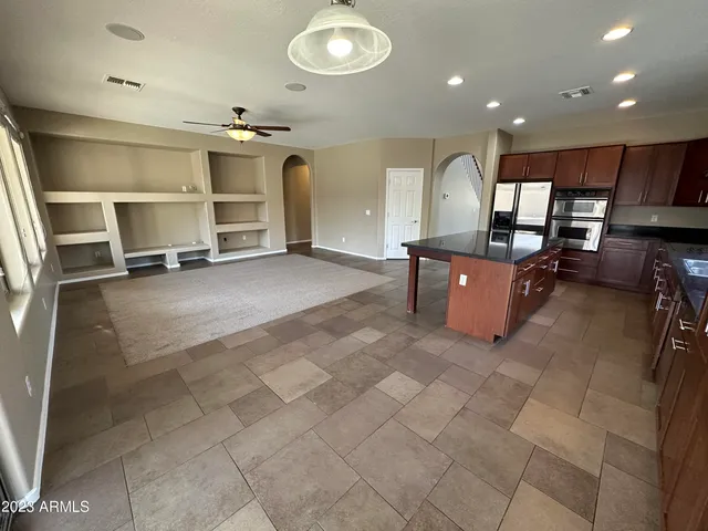 a living room with furniture a ceiling fan and a rug
