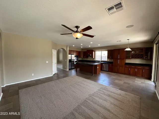 a view of kitchen with furniture and a ceiling fan