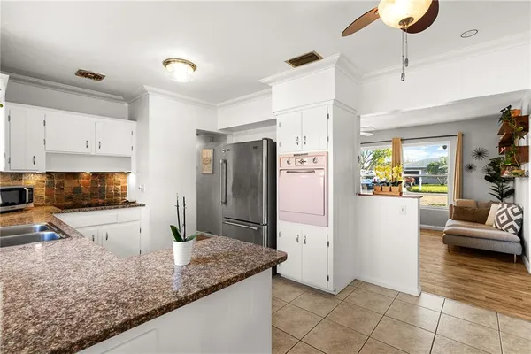 a kitchen with stainless steel appliances granite countertop a refrigerator and a sink