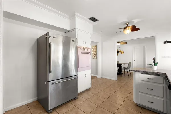 a kitchen with stainless steel appliances a refrigerator sink and cabinets