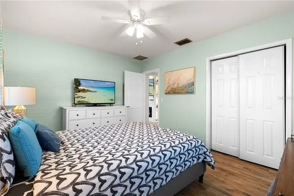 a bedroom with a large bed and a flat screen tv
