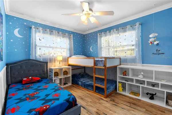 a bedroom with furniture and a baby crib