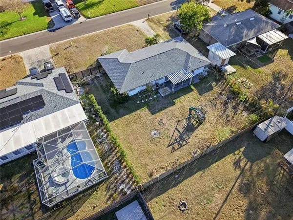 an aerial view of a house with a yard