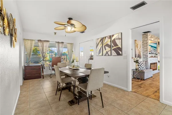 a view of a dining room with furniture and a floor to ceiling window