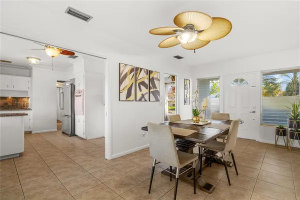 a view of a dining room with furniture and chandelier