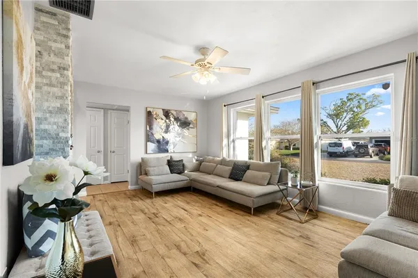 a living room with furniture and wooden floor