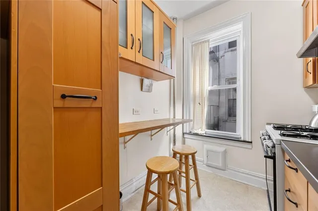 a kitchen with stainless steel appliances a stove microwave and cabinets